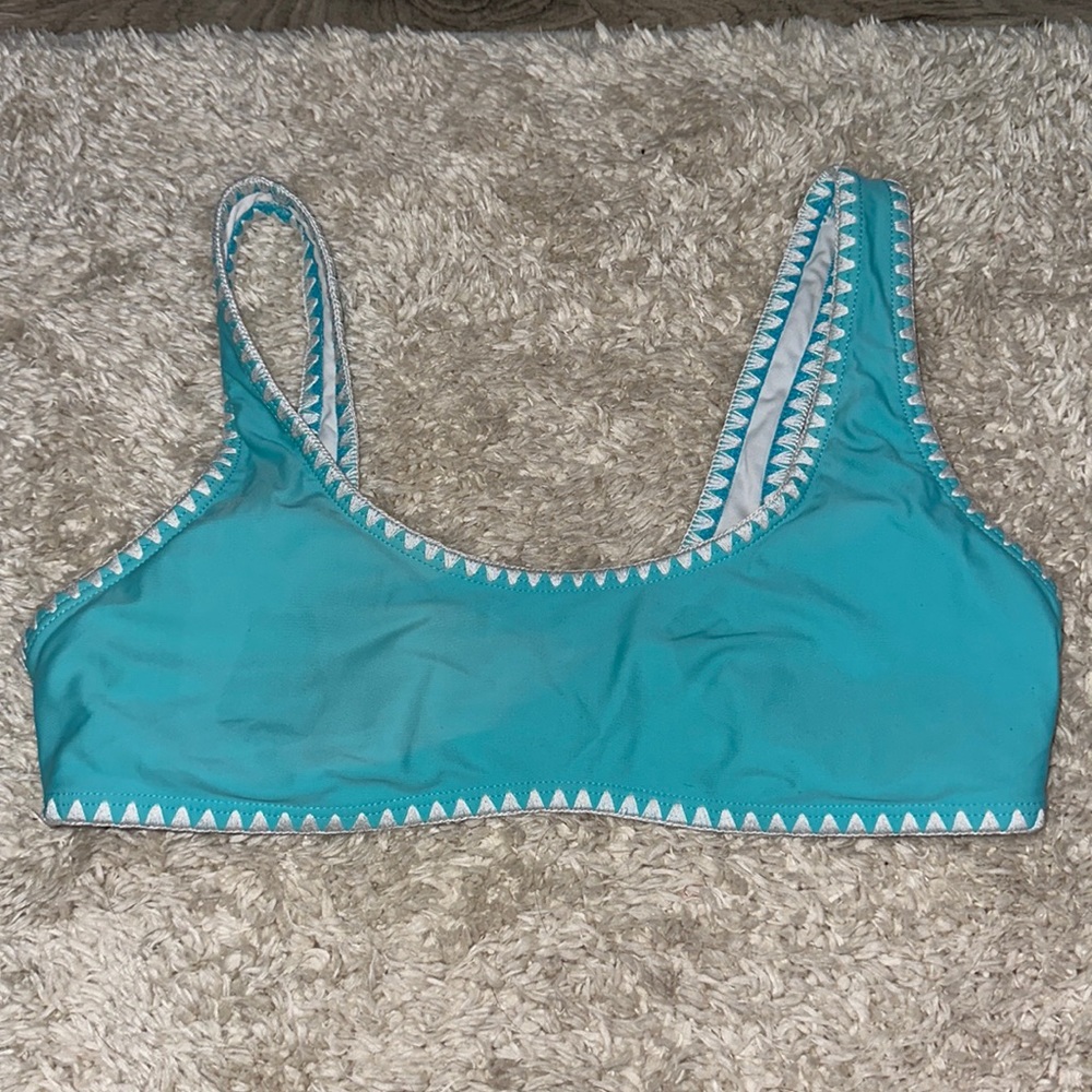 light blue/teal and white bikini top, worn very lightly